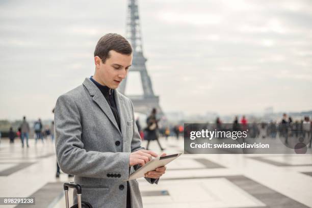 young business ma in paris using digital tablet, france - esplanade du trocadero stock pictures, royalty-free photos & images