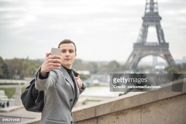 businessman in paris using smart phone to take selfie - esplanade du trocadero stock pictures, royalty-free photos & images