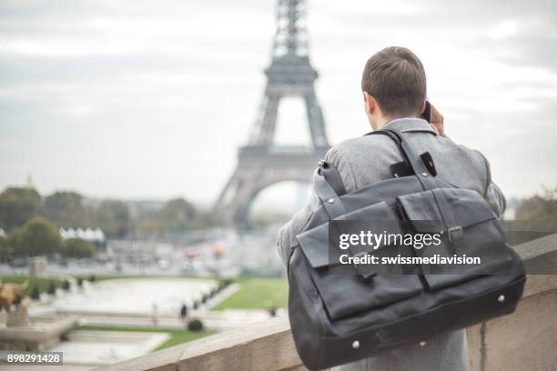 businessman travel man on the phone in paris, eiffel tower - esplanade du trocadero stock pictures, royalty-free photos & images