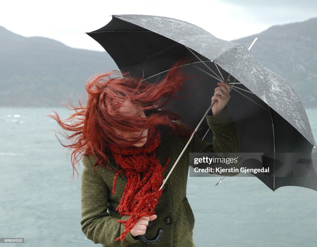 Girl with umbrella and blowing hair