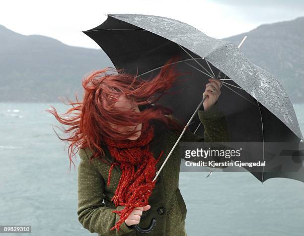 girl with umbrella and blowing hair - chuva imagens e fotografias de stock