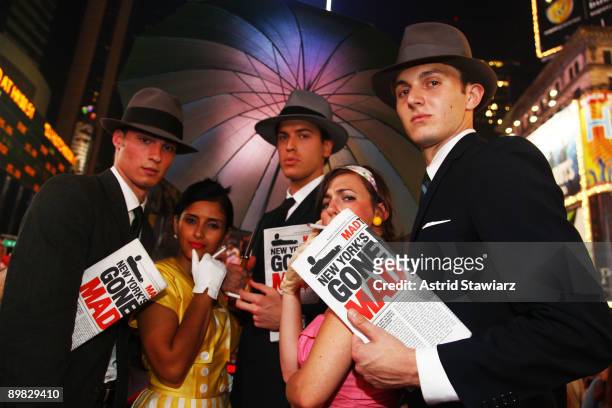 Models pose dressed in character for "Mad Men" season 3 premieres on the big screen In Times Square on August 16, 2009 in New York City.