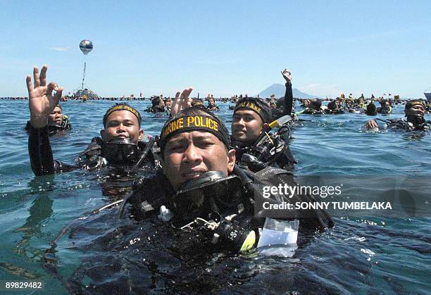 Group of Indonesian Marine Police gesture in the waters off Manado, in North Sulawesi on August 17, 2009 as part of a mass dive by 2,486 scuba divers...