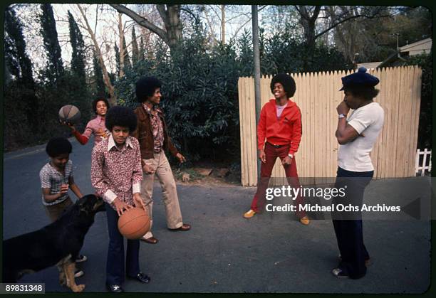 The Jackson brothers play basketball in the backyard of their home, Los Angeles, 1972. From left to right, Randy Jackson, Marlon Jackson, Michael...