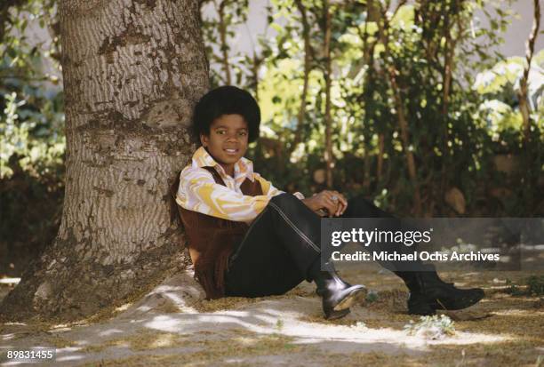 American singer Michael Jackson relaxes under a tree, April 1970.
