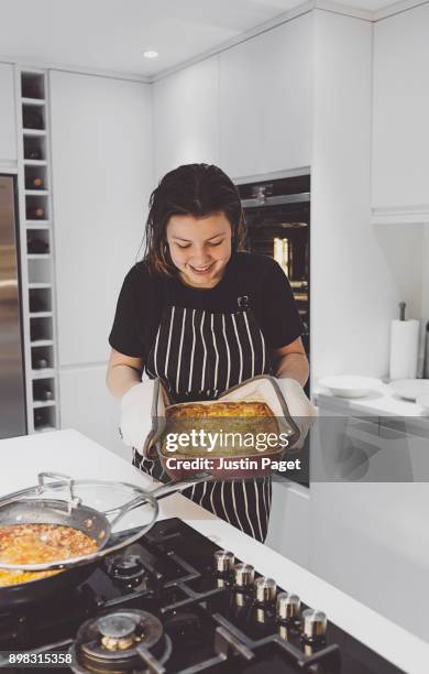 teen girl with homemade lasagna - lasagne stock pictures, royalty-free photos & images