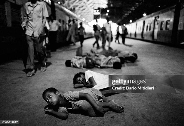 Street children from the Victoria Terminus gang waking up on platform 7 at Victoria Terminus station in Bombay.