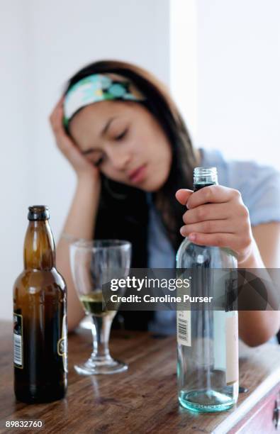 mixed-race teenager drinking alcohol alone - teenagers only stock pictures, royalty-free photos & images