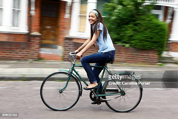 mixed-race teenager riding bicycle - ride london stockfoto's en -beelden