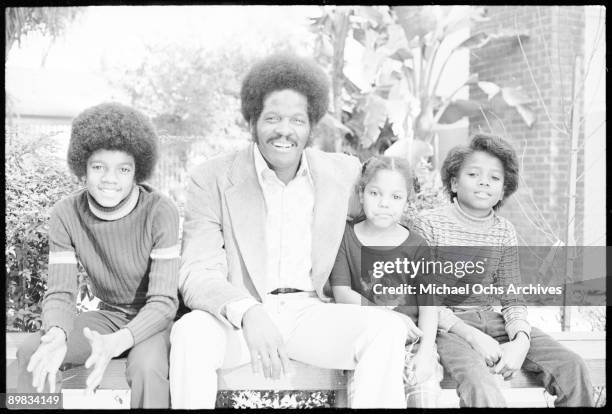 From left to right, American singer Michael Jackson , an unknown man, and singers Janet and Randy Jackson, at the Jacksons' home in Los Angeles, 18th...
