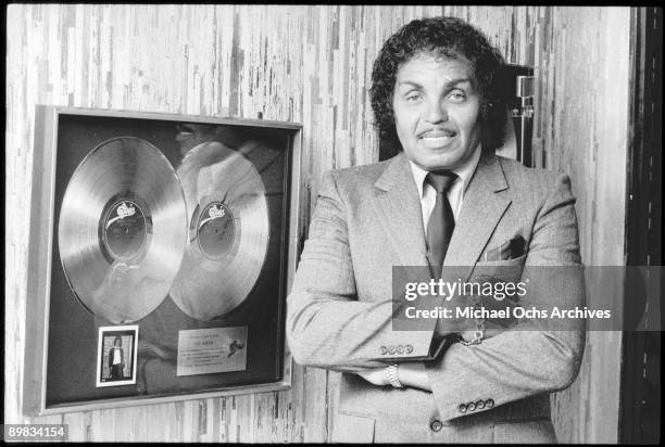 Joseph Jackson, father and manager of The Jackson Five, poses by an Epic double platinum award, circa 1982.