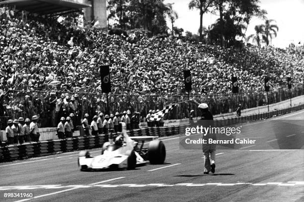 Carlos Pace, Brabham-Ford BT44B, Grand Prix of Brazil, Interlagos, 26 January 1975. Carlos Pace take the checkered flag and victory in the 1975...