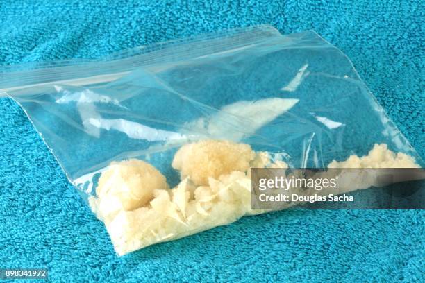 bag of illegal drugs on a blue background - crack cocaine fotografías e imágenes de stock