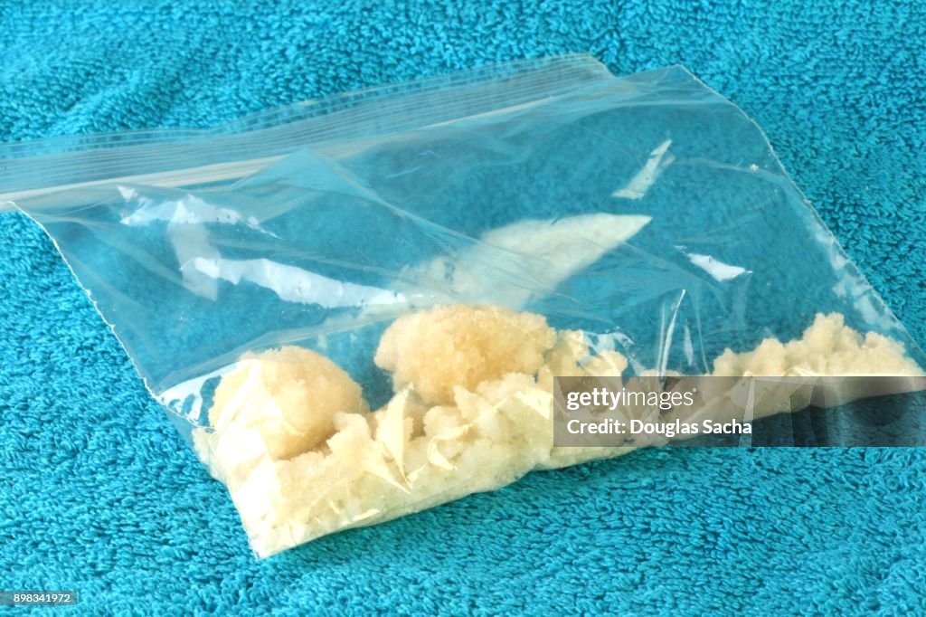 Bag of illegal drugs on a blue background