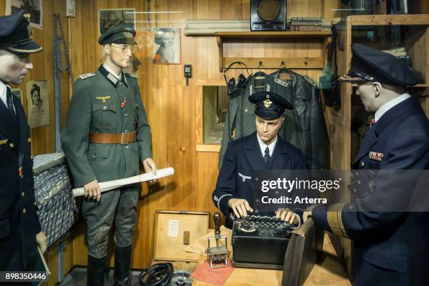 German WWII officer using 3-rotor Wehrmacht Enigma machine at Raversyde Atlantikwall / Atlantic Wall museum at Raversijde, Flanders, Belgium.