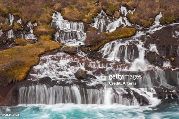 Hraunfossar, series of waterfalls pouring into the Hvita river in winter, Vesturland, Borgarfjorour, western Iceland.