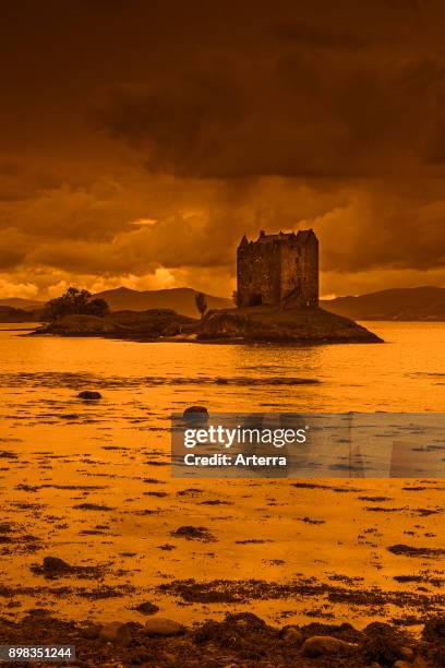 Castle Stalker at sunset, medieval four-story tower house / keep in Loch Laich, inlet off Loch Linnhe near Port Appin, Argyll, Scotland, United...