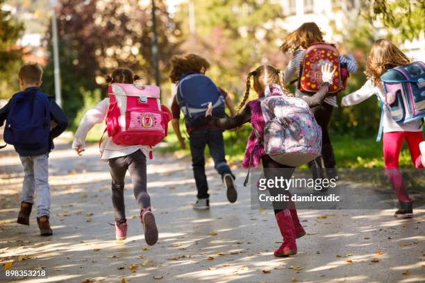 children having fun outdoors - elementary school building stock pictures, royalty-free photos & images
