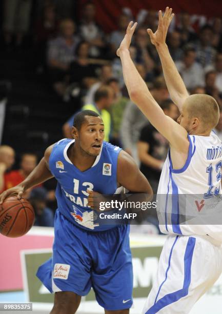 French Boris Diaw tries to get past Finland's Hanno Möttölä during the basketball Euro Championships qualification match in Vantaa, Finland on August...