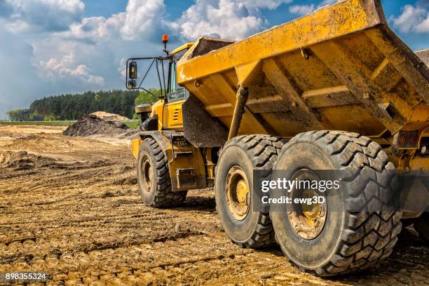 the yellow dump truck on the construction of highway s6, goleniów, poland - dump truck stock pictures, royalty-free photos & images