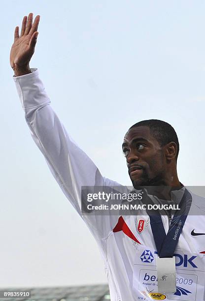 Tyson Gay poses on the podium during the men's 100m race medal ceremony of the 2009 IAAF Athletics World Championships on August 17, 2009 in Berlin....