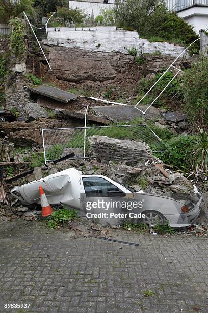 landslide with crushed car - erdrutsch stock-fotos und bilder