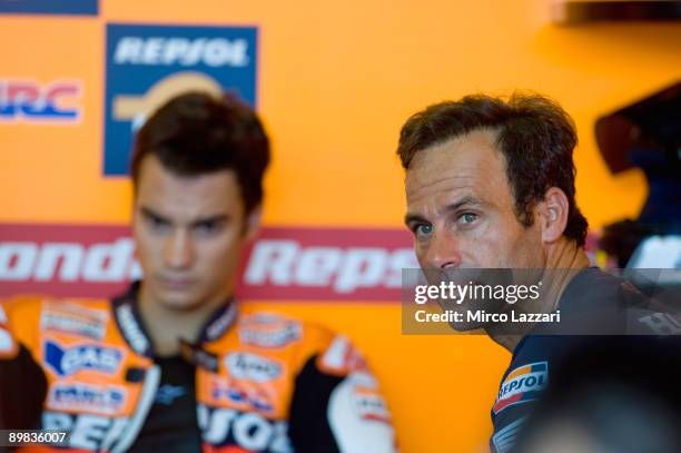 Alberto Puig of Spains look on near Dani Pedrosa of Spain and Repsol Honda Team in box during the monday MotoGP test in Brno Circuit on August 17,...
