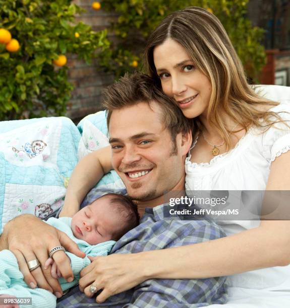 Christopher Backus and Mira Sorvino pose with newborn son Holden Backus during an at home photo shoot on July 1, 2009 in Malibu, California.