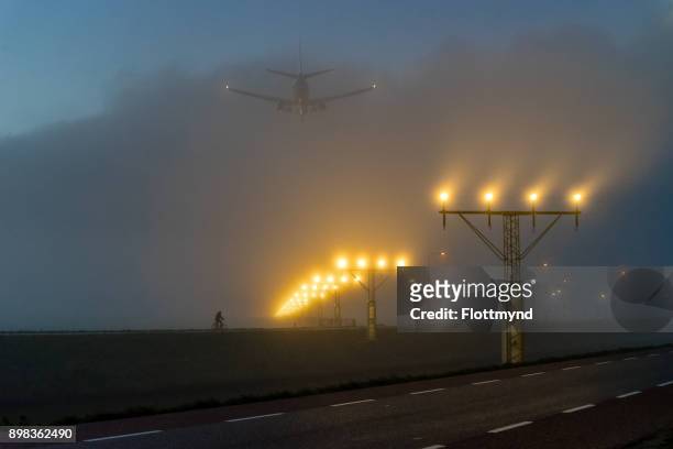 amsterdam schiphol airport, runway with fog, netherlands - haarlemmermeer stock pictures, royalty-free photos & images