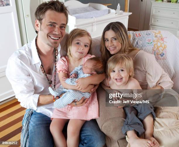 Christopher Backus and Mira Sorvino pose with daughter Mattea Backus, newborn son Holden Backus and son Johnny Backus during an at home photo shoot...