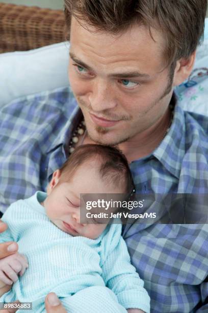 Christopher Backus poses with newborn son Holden Backus during an at home photo shoot on July 1, 2009 in Malibu, California.