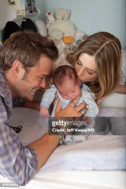 Christopher Backus and Mira Sorvino pose with newborn son Holden Backus during an at home photo shoot on July 1, 2009 in Malibu, California.