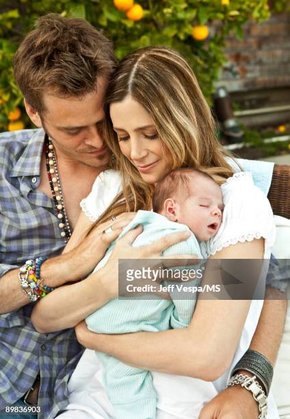Christopher Backus and Mira Sorvino pose with newborn son Holden Backus during an at home photo shoot on July 1, 2009 in Malibu, California.