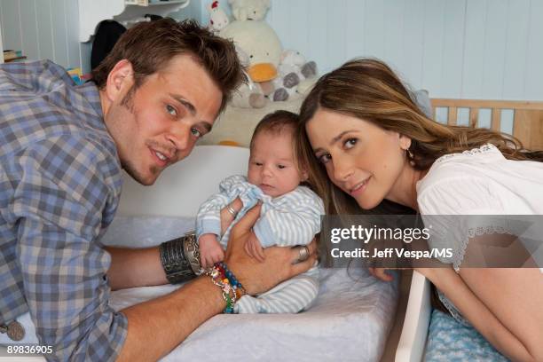 Christopher Backus and Mira Sorvino pose with newborn son Holden Backus during an at home photo shoot on July 1, 2009 in Malibu, California.