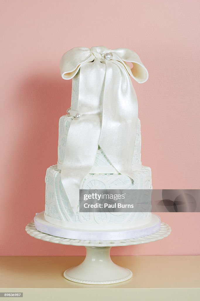Three-Tiered Wedding Cake With White Satin Bow