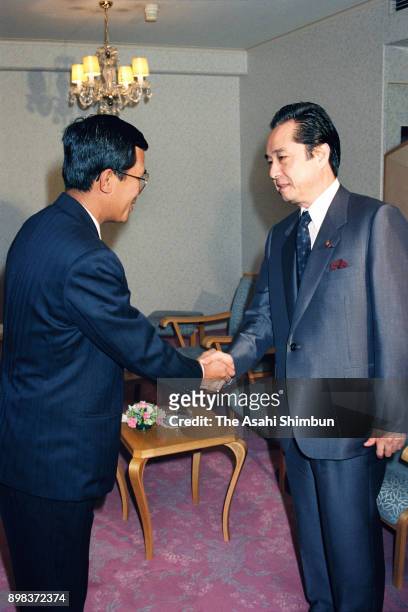 People's Republic of Kampuchea Prime Minister Hun Sen shakes hands with Democratic Socialist Party leader Keigo Ouchi prior to their meeting on June...