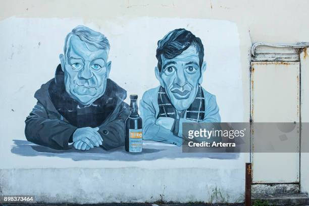 Mural showing the actors Jean Gabin and Jean-Paul Belmondo from the 1962 French film Un singe en hiver at Villerville, Calvados, Normandy, France.