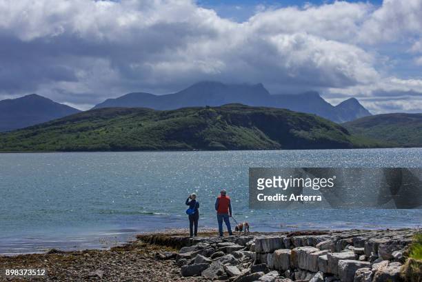 Tourists looking over Ben Loyal and Kyle of Tongue, shallow sea loch in northwest Highland, Sutherland, Scottish Highlands, Scotland, UK.