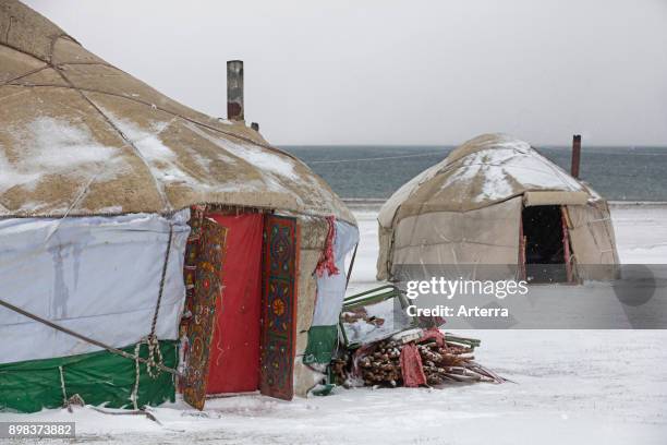 Yurts in traditional Kyrgyz yurt camp during snow storm along Song Kul / Song Kol lake in the Tian Shan Mountains, Naryn Province, Kyrgyzstan.