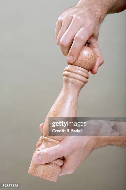 two human hands using a pepper mill - pepper mill bildbanksfoton och bilder