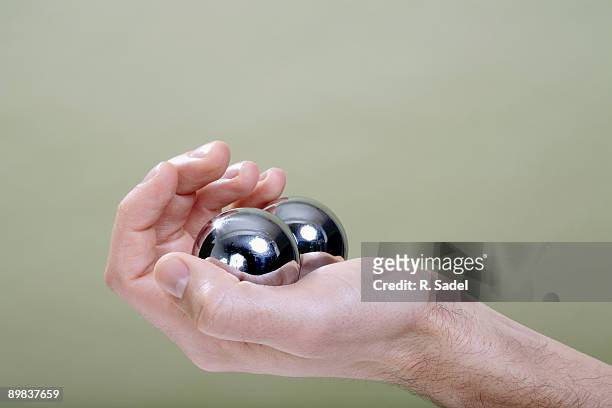 a human hand holding chinese medicine balls - holding two things stock pictures, royalty-free photos & images