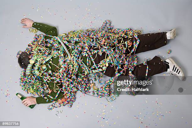 a man passed out and covered in streamers - after party mess stock pictures, royalty-free photos & images