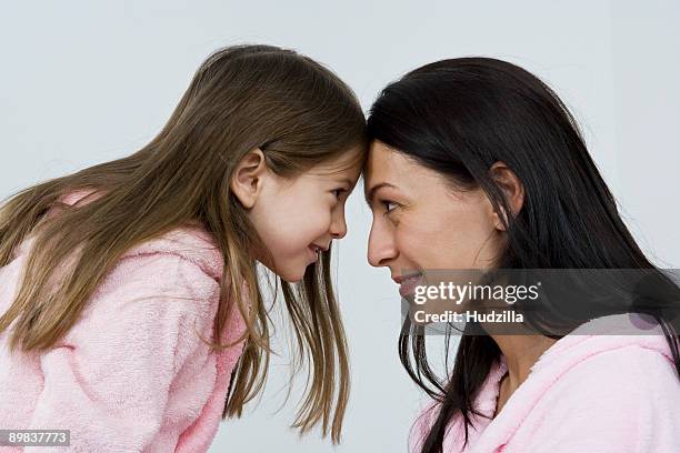 a mother and daughter wearing pink bathrobes - bathrobe stock pictures, royalty-free photos & images