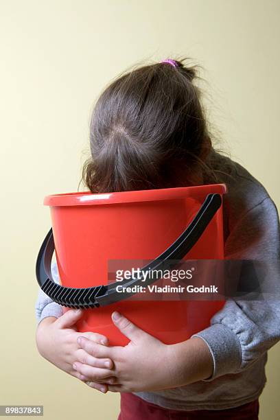 a young girl being sick in a bucket - vomiting stock pictures, royalty-free photos & images