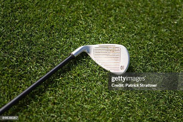 a golf club on grass - club de golf photos et images de collection