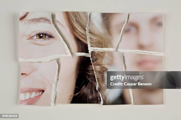 a photograph of a heterosexual couple torn into pieces - couple relationship fotos stockfoto's en -beelden