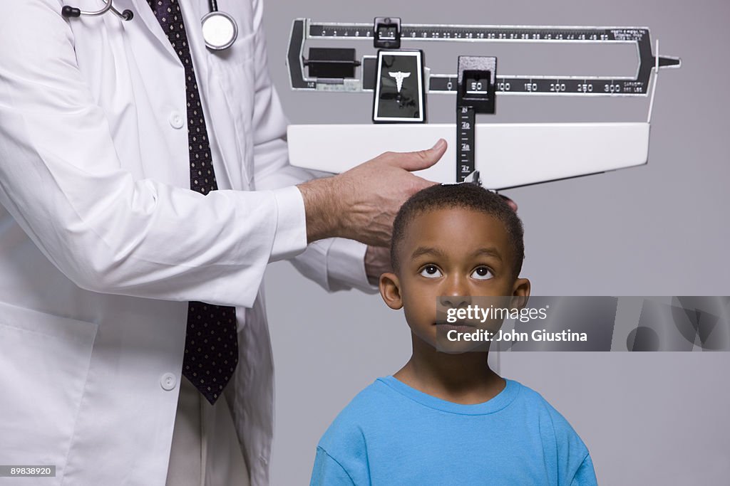 Doctor measuring child's height. 