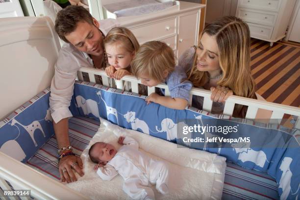 Chris Backus and Mira Sorvino pose with daughter Mattea Backus, newborn son Holden Backus and son Johnny Backus during an at home photo shoot on July...