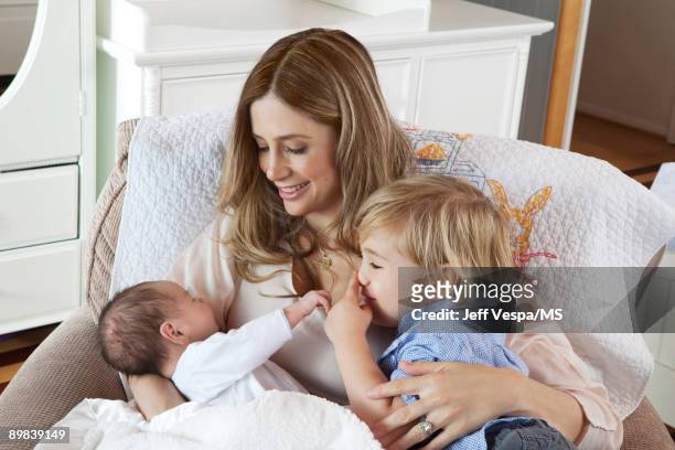 Mira Sorvino poses with sons Holden Backus and Johnny Backus during an at home photo shoot on July 1, 2009 in Malibu, California.