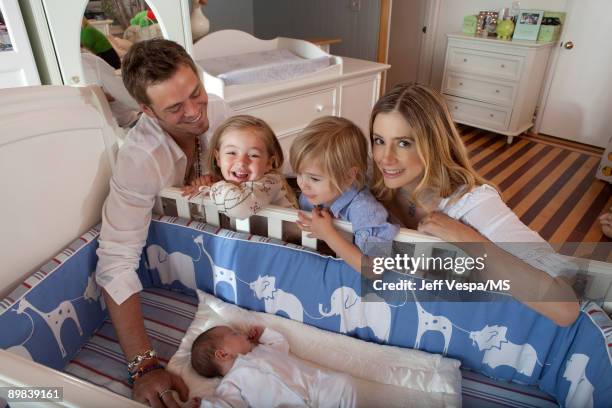 Chris Backus and Mira Sorvino pose with daughter Mattea Backus, newborn son Holden Backus and son Johnny Backus during an at home photo shoot on July...